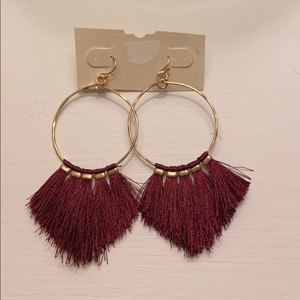 Gold hoop earrings with maroon tassels